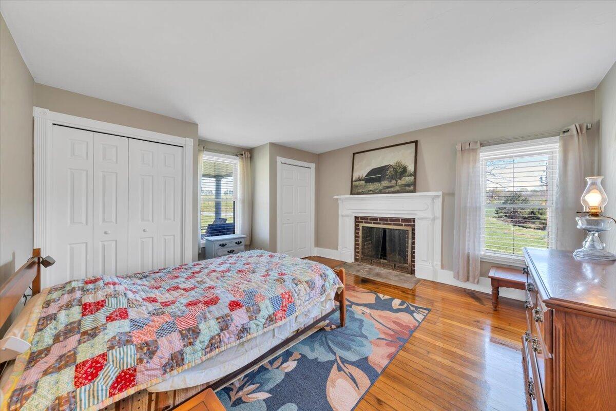 3861 Wheatland Road Bedford, VA 24523 - Photo 18 of 99 a bedroom with a bed and a fireplace