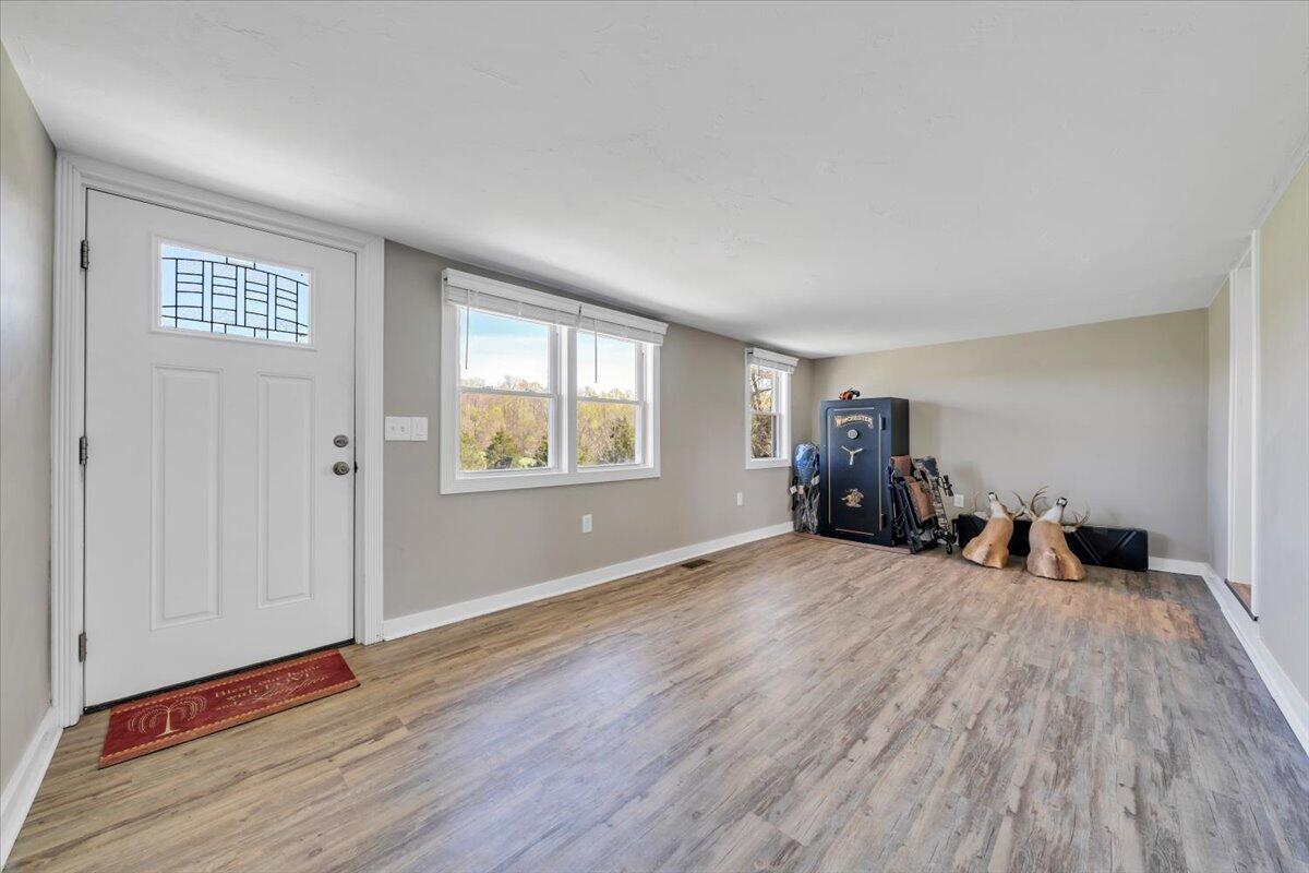 3861 Wheatland Road Bedford, VA 24523 - Photo 19 of 99 a view of a livingroom with wooden floor and a window