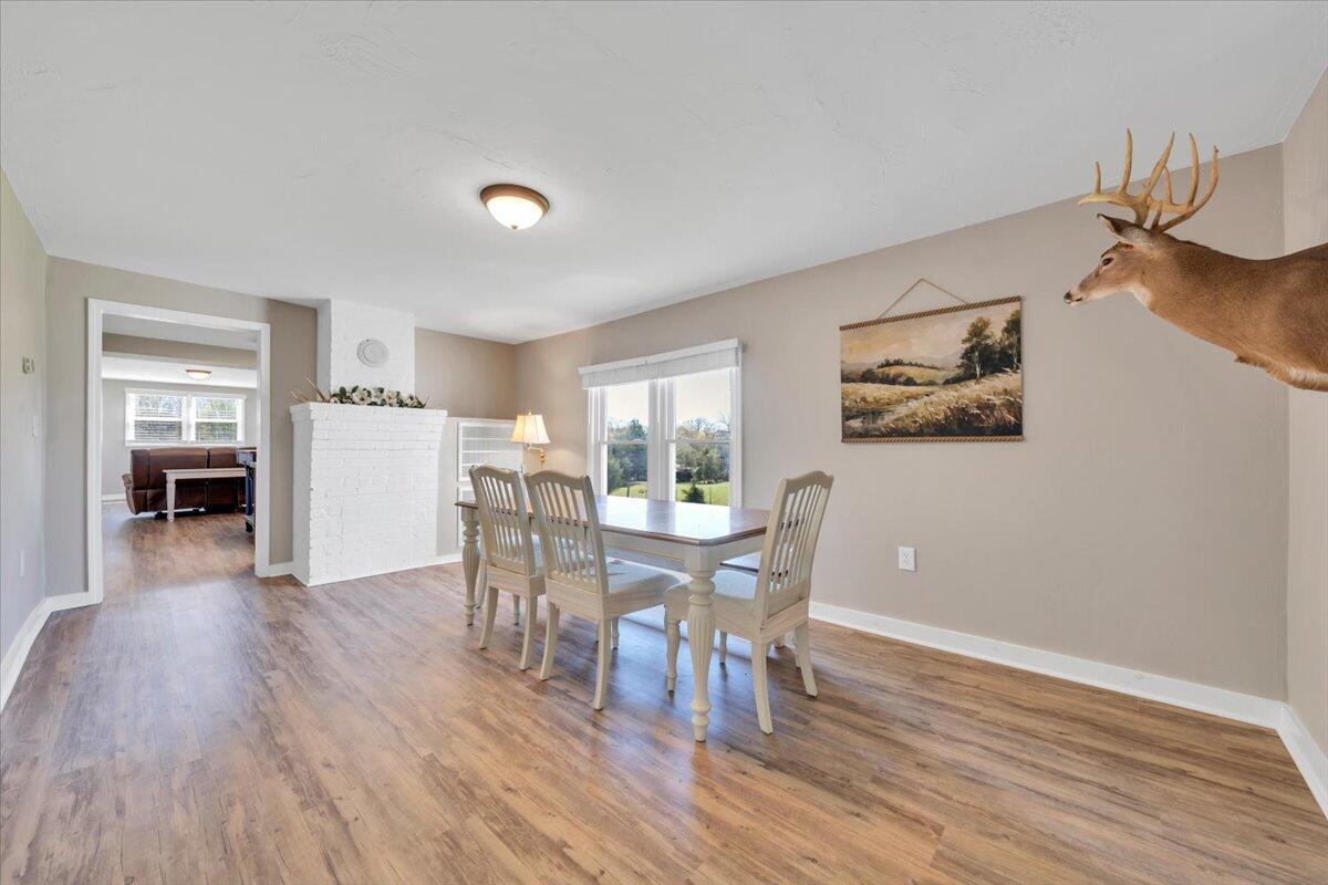 3861 Wheatland Road Bedford, VA 24523 - Photo 21 of 99 a view of a dining room with furniture and wooden floor