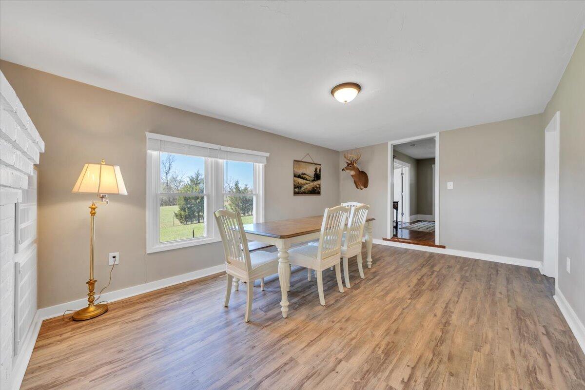 3861 Wheatland Road Bedford, VA 24523 - Photo 22 of 99 a dining room with furniture and wooden floor