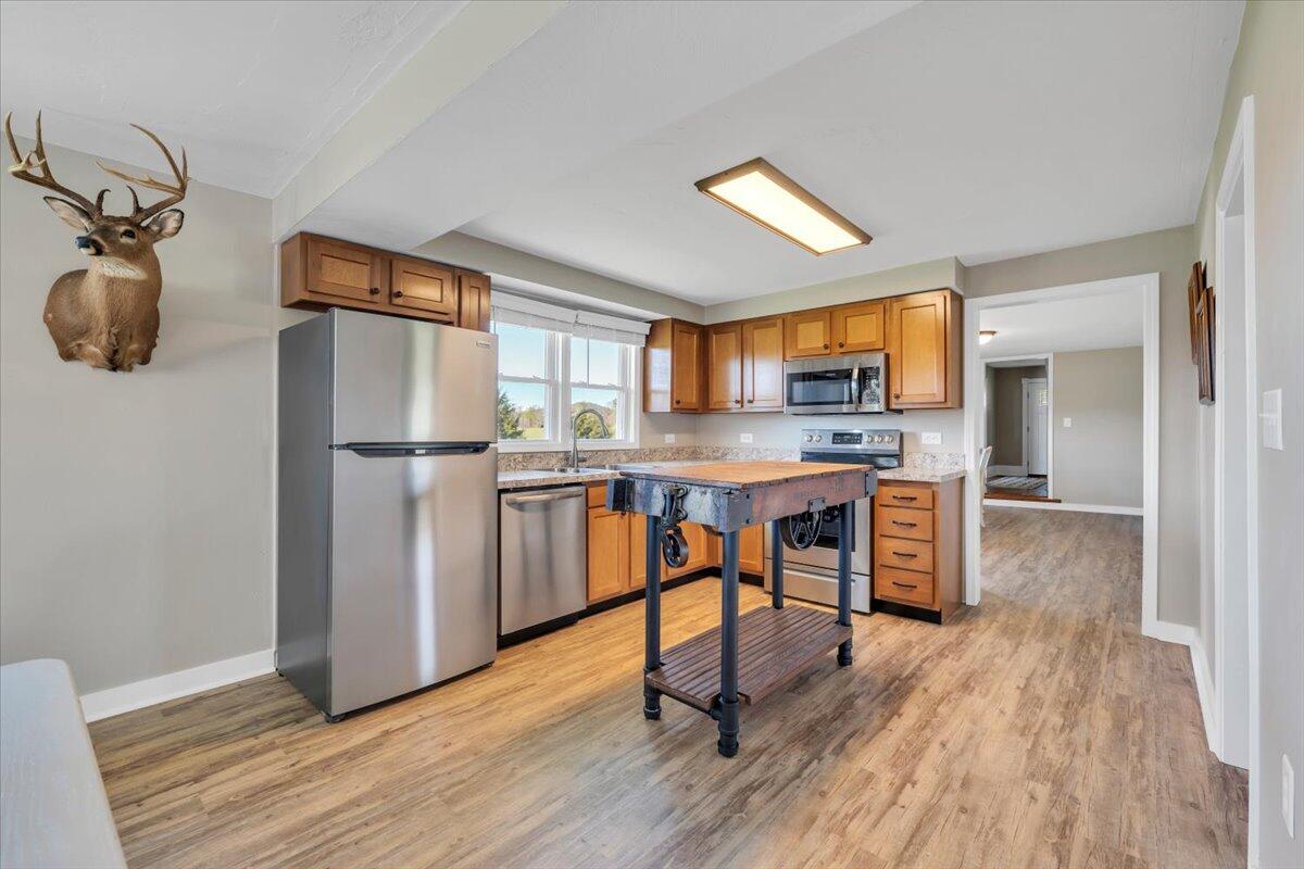 3861 Wheatland Road Bedford, VA 24523 - Photo 23 of 99 a kitchen with stainless steel appliances a refrigerator stove microwave and cabinets