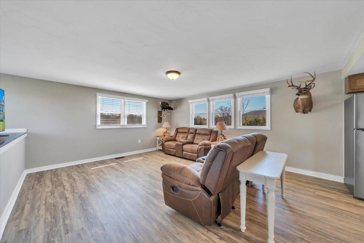 3861 Wheatland Road Bedford, VA 24523 - Photo 30 of 99 a living room with furniture and a wooden floor