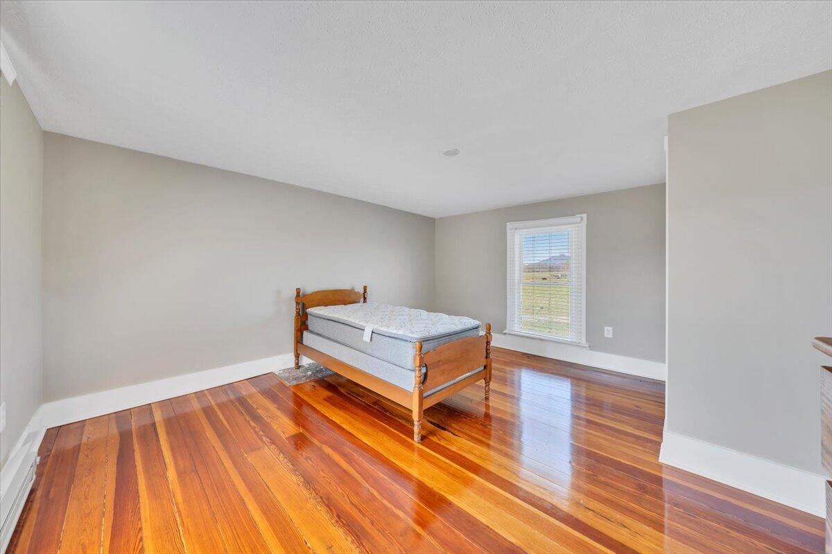 3861 Wheatland Road Bedford, VA 24523 - Photo 43 of 99 a room with wooden floor and furniture