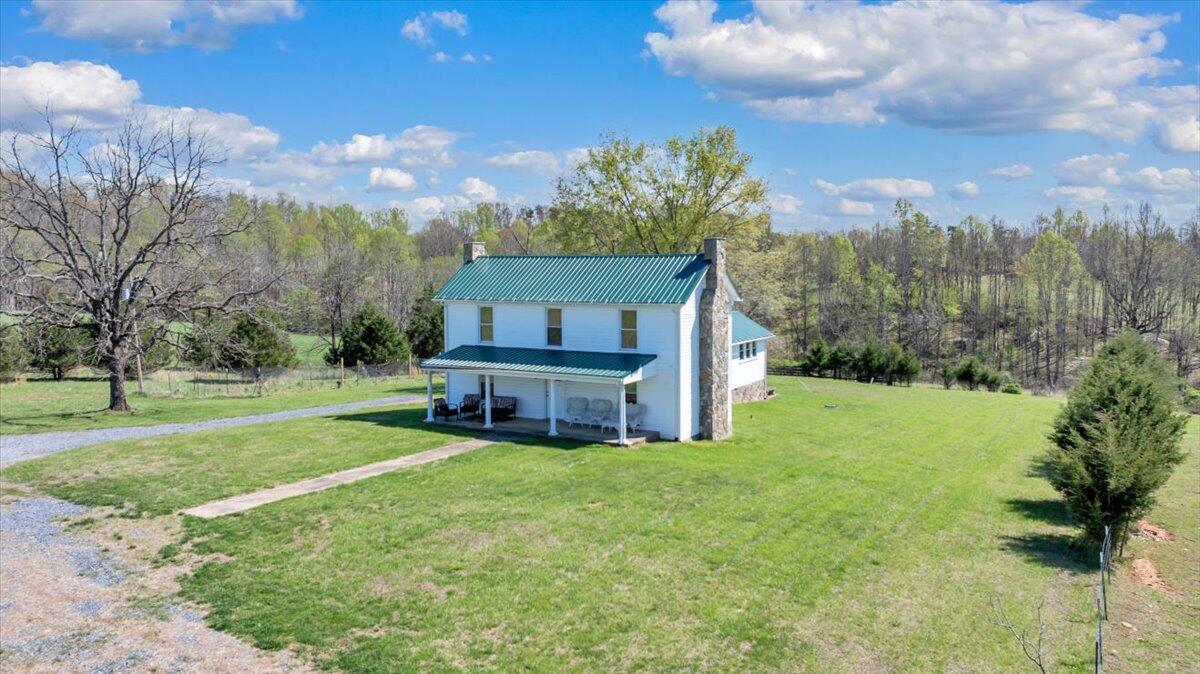 3861 Wheatland Road Bedford, VA 24523 - Photo 63 of 99 a view of a house with a big yard potted plants and large tree