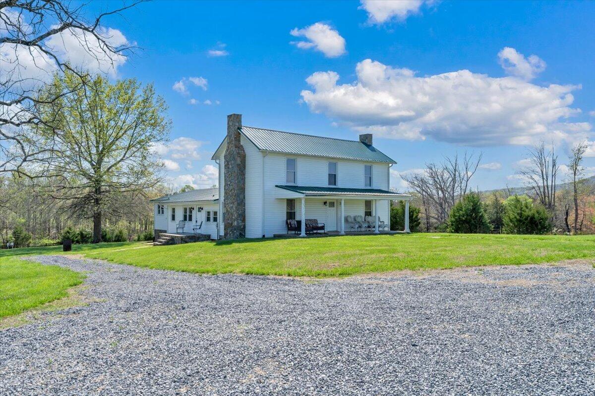 3861 Wheatland Road Bedford, VA 24523 - Photo 8 of 99 a view of a big house with a big yard and large trees