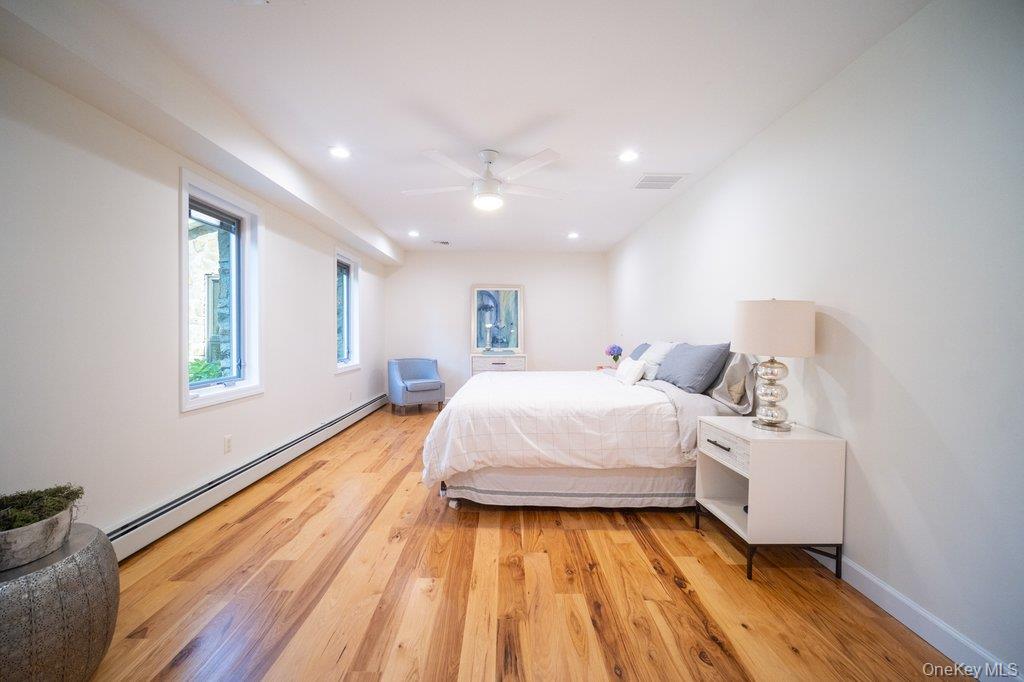 237 Mineral Springs Road Highland Mills, NY 10930 - Photo 18 of 32 Bedroom with a baseboard heating unit, light wood finished floors, recessed lighting, and a ceiling fan