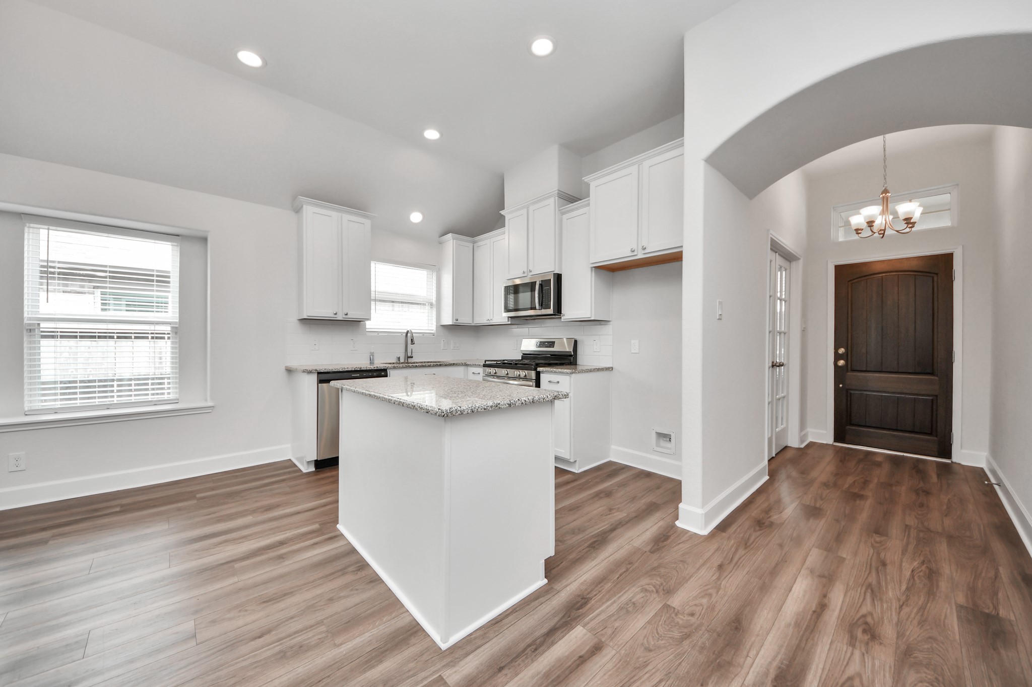 1614 Diamond Mountain Drive Rosharon, TX 77583 - Photo 6 of 40 a kitchen with a refrigerator and white cabinets