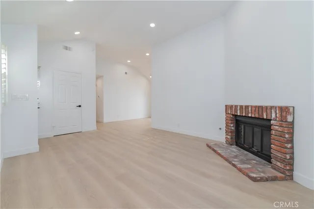 a view of empty room with a fireplace