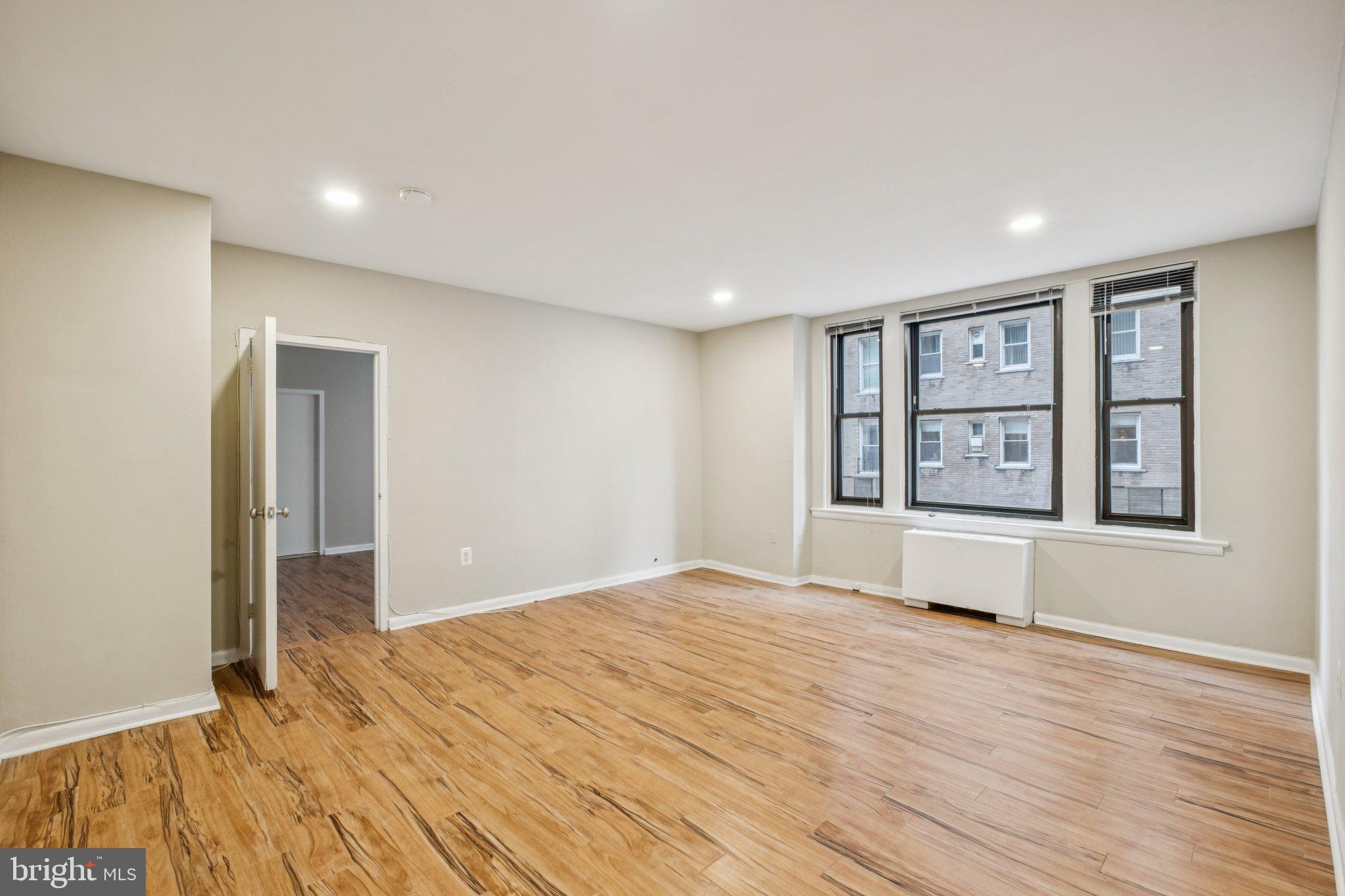 135 South 19th Street, Unit 908 Philadelphia, PA 19103 - Photo 2 of 18 a view of an empty room with window and wooden floor