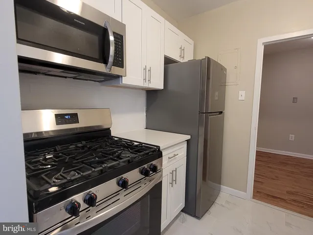 a stove top oven sitting inside of a kitchen