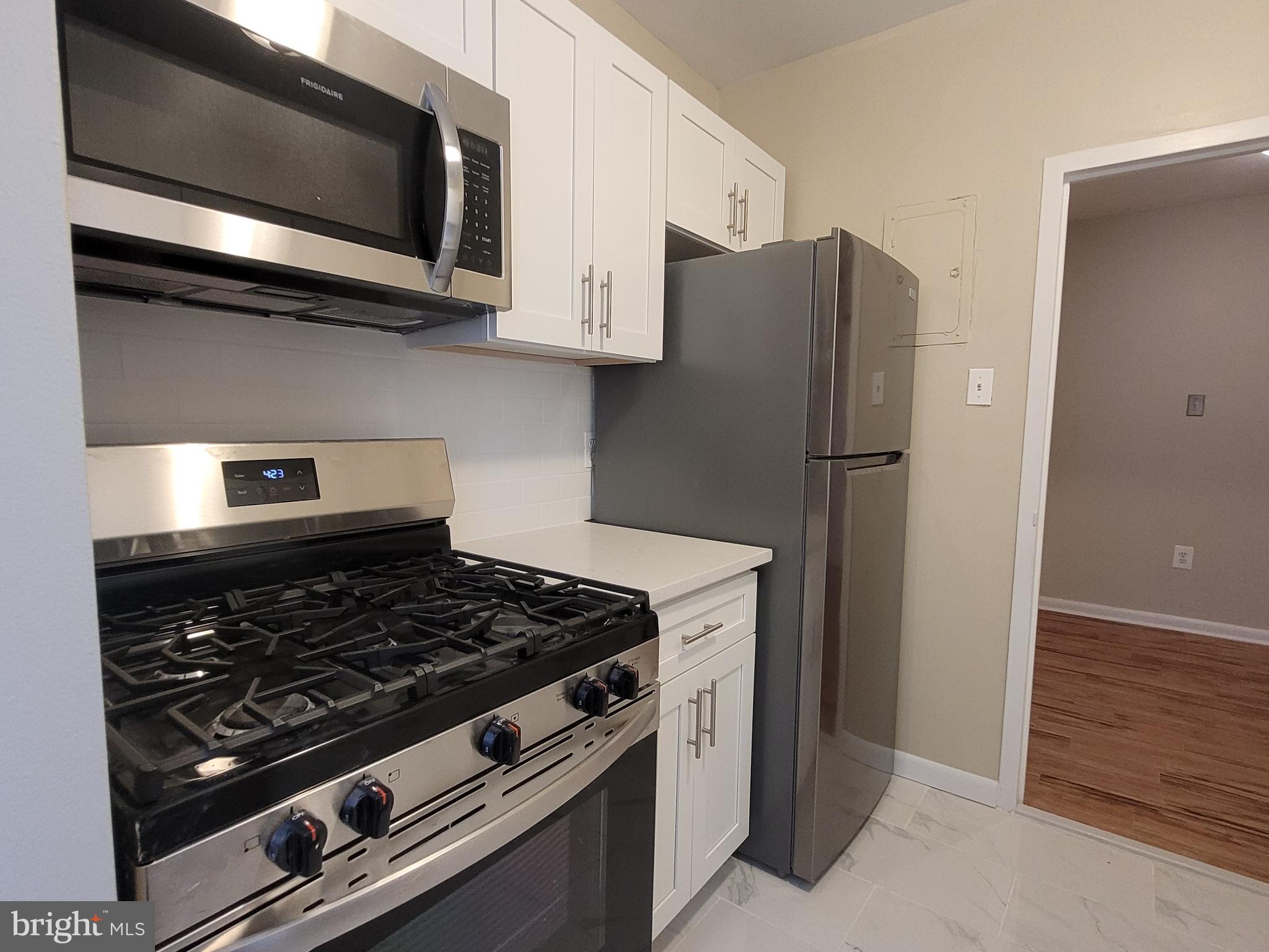 135 South 19th Street, Unit 908 Philadelphia, PA 19103 - Photo 8 of 20 a stove top oven sitting inside of a kitchen