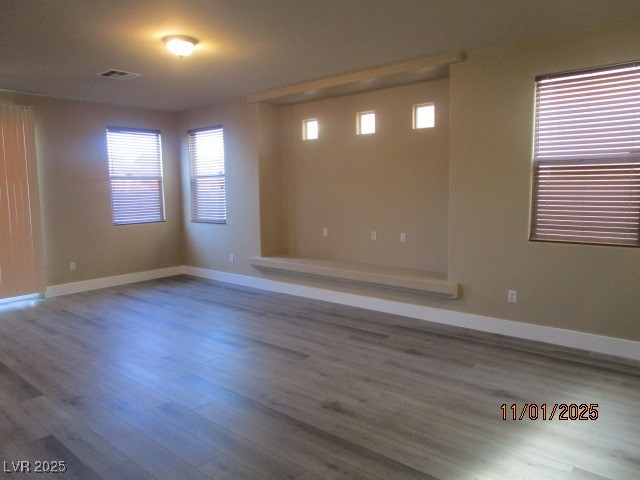 9014 Rutherford Grove Street Las Vegas, NV 89148 - Photo 3 of 22 Unfurnished room featuring plenty of natural light and wood finished floors
