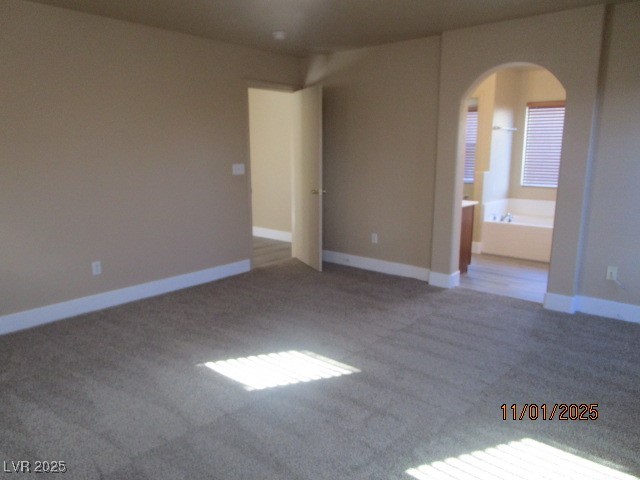 9014 Rutherford Grove Street Las Vegas, NV 89148 - Photo 8 of 22 Spare room featuring arched walkways and carpet floors