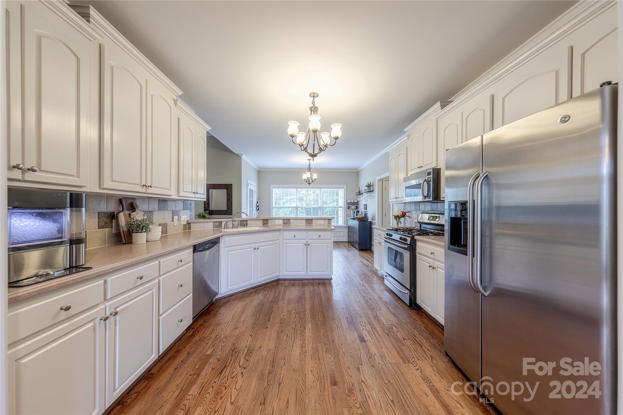 3321 Millstone Creek Road Lancaster, SC 29720 - Photo 14 of 48 a large kitchen with cabinets wooden floor and stainless steel appliances
