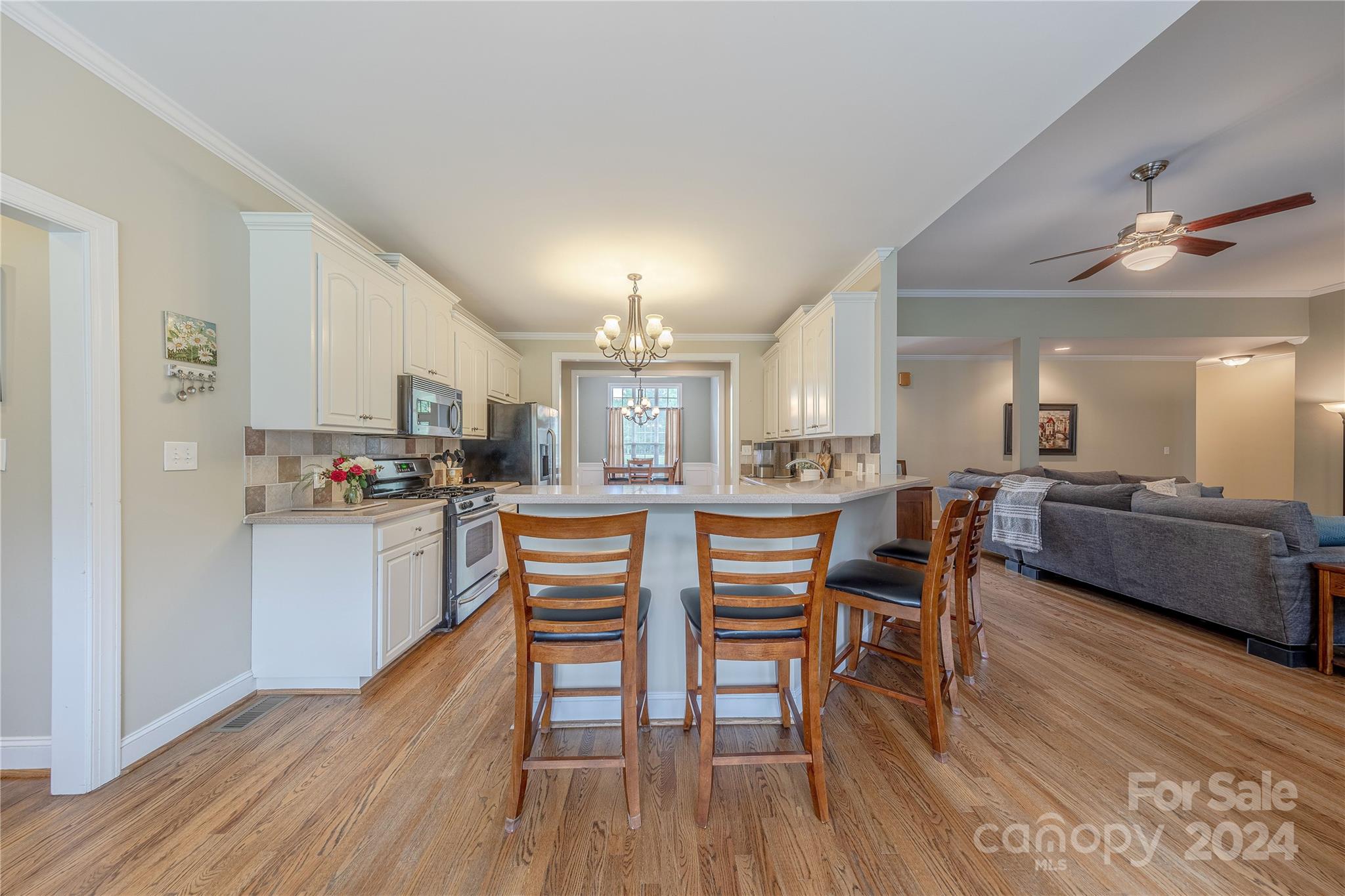 3321 Millstone Creek Road Lancaster, SC 29720 - Photo 16 of 48 a kitchen with stainless steel appliances a dining table chairs and wooden floor