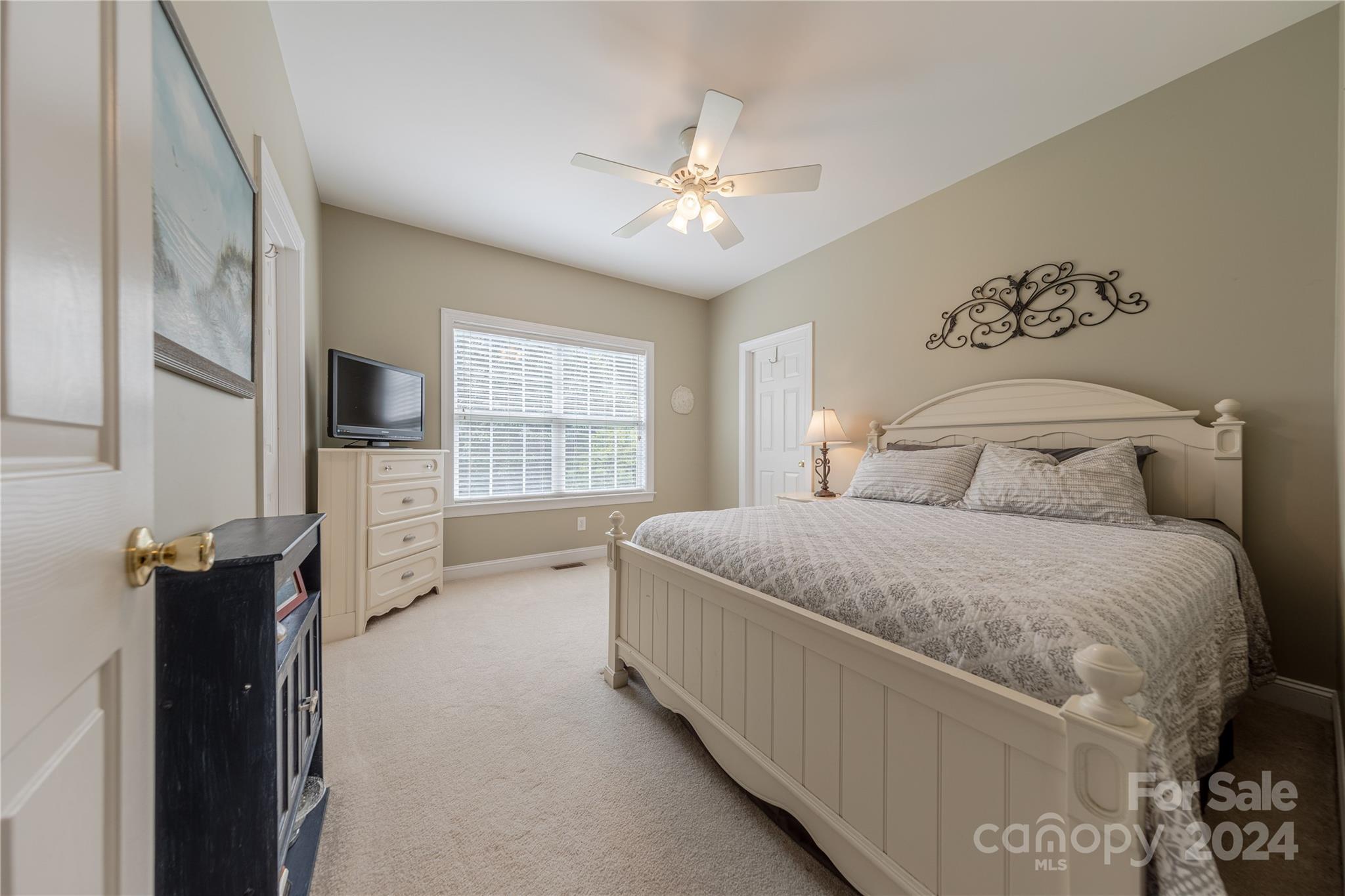 3321 Millstone Creek Road Lancaster, SC 29720 - Photo 33 of 48 a bedroom with a large bed and a chandelier
