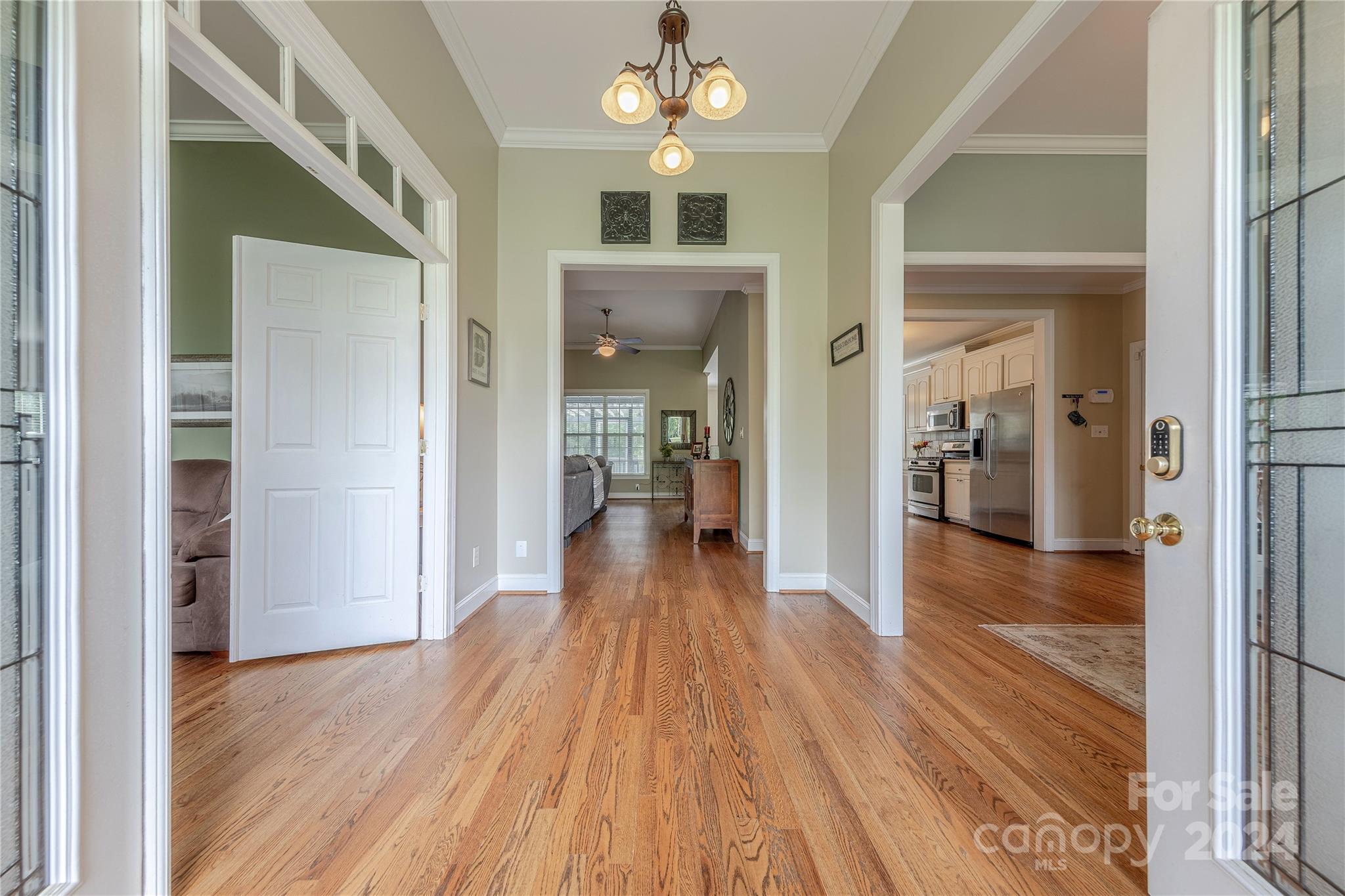 3321 Millstone Creek Road Lancaster, SC 29720 - Photo 5 of 48 a view of a hallway with wooden floor and a chandelier