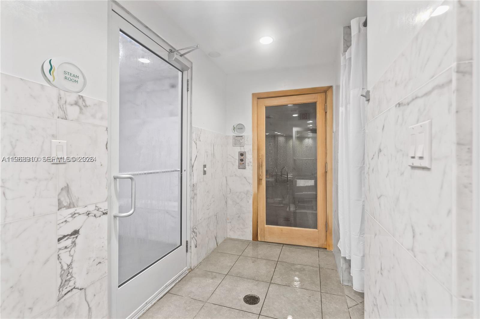 253 Northeast 2nd Street, Unit 433 Miami, FL 33132 - Photo 19 of 32 a bathroom with a shower and mirror