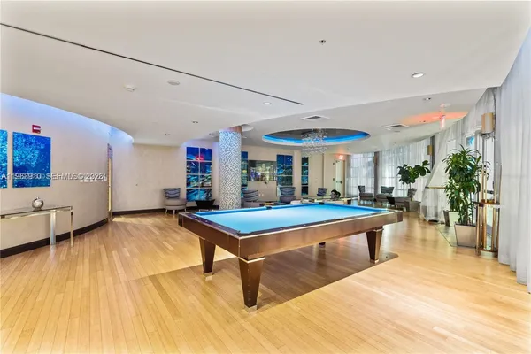 a living room with furniture and large windows