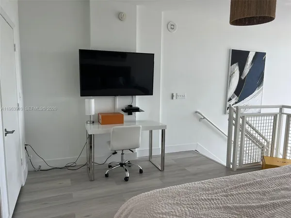 a view of a livingroom with furniture and a flat screen tv