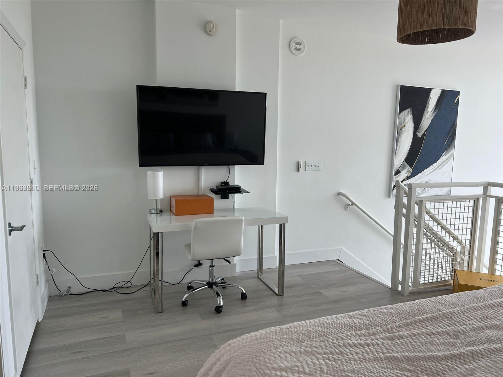 253 Northeast 2nd Street, Unit 433 Miami, FL 33132 - Photo 4 of 32 a view of a livingroom with furniture and a flat screen tv
