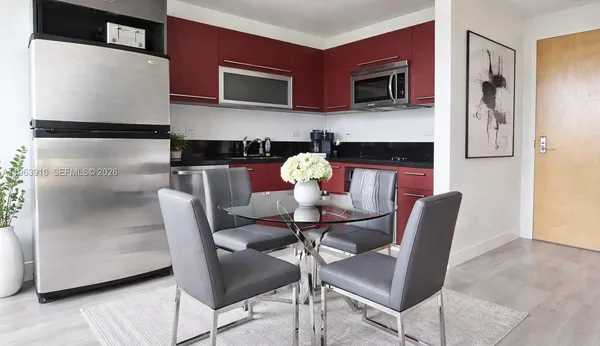 a kitchen with stainless steel appliances kitchen island granite countertop furniture and a refrigerator