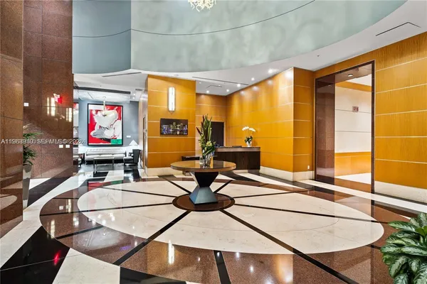 a living room with patio furniture and floor to ceiling window