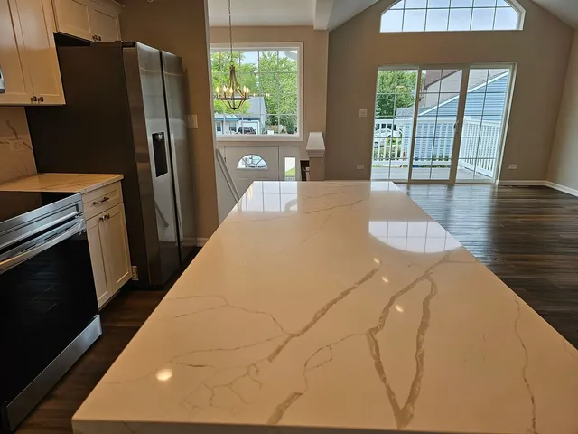 a large white kitchen with a large window