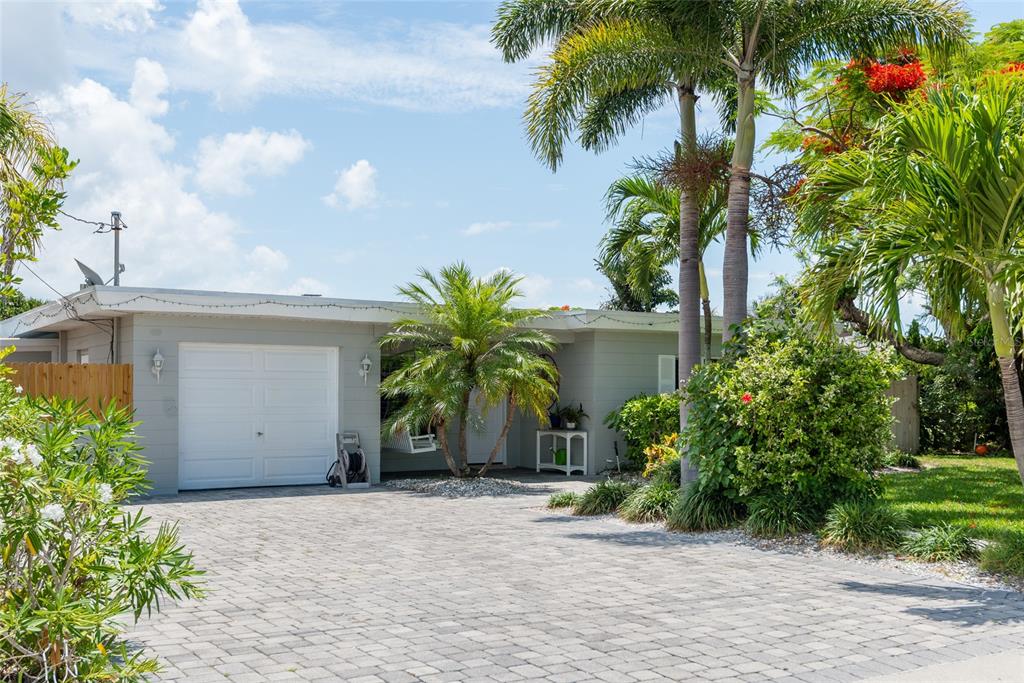 403 Normandy Road Madeira Beach, FL 33708 - Photo 1 of 1 a front view of a house with a yard and a garage