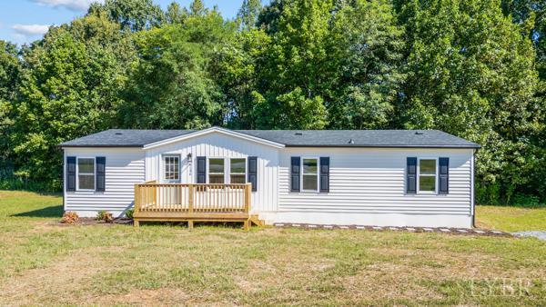 a white house that has a tree in front of it