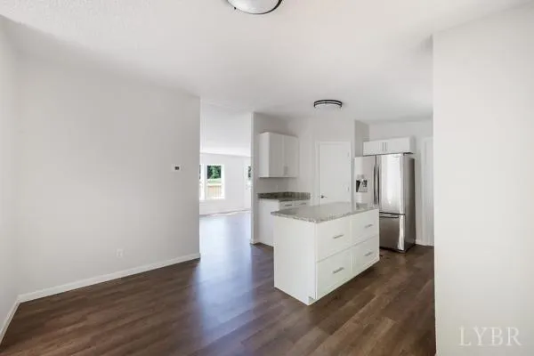 a kitchen with a sink cabinets stainless steel appliances and a window
