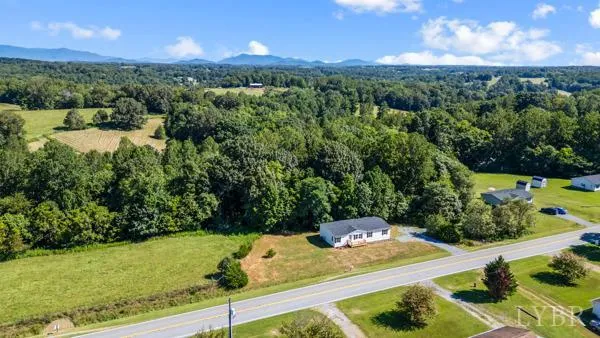 a view of a yard with table & chairs