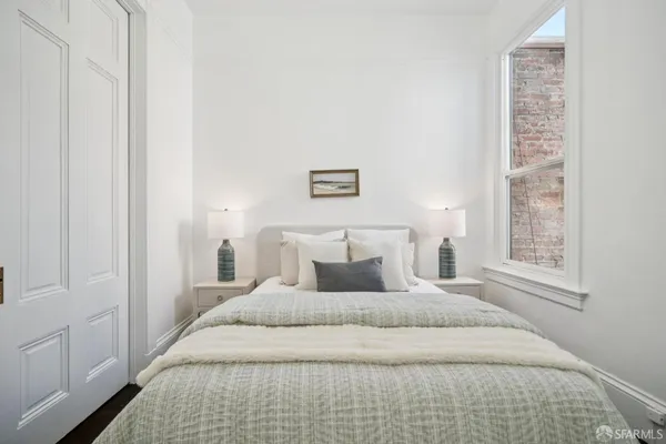 a bedroom with a bed and a mirror