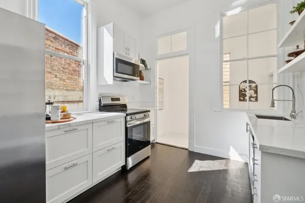a bathroom with a granite countertop sink and a toilet