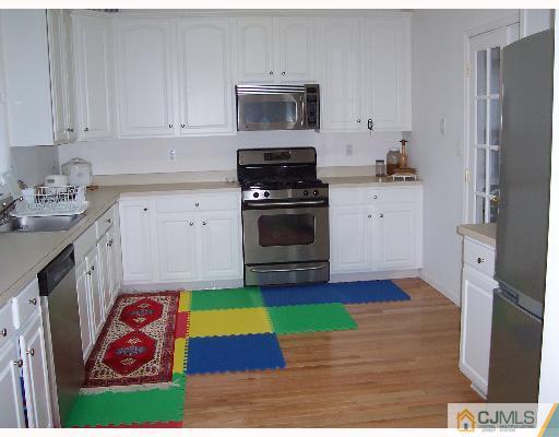 47 Westley Road Old Bridge, NJ 08857 - Photo 4 of 7 a kitchen with stainless steel appliances kitchen island granite countertop a refrigerator sink and stove