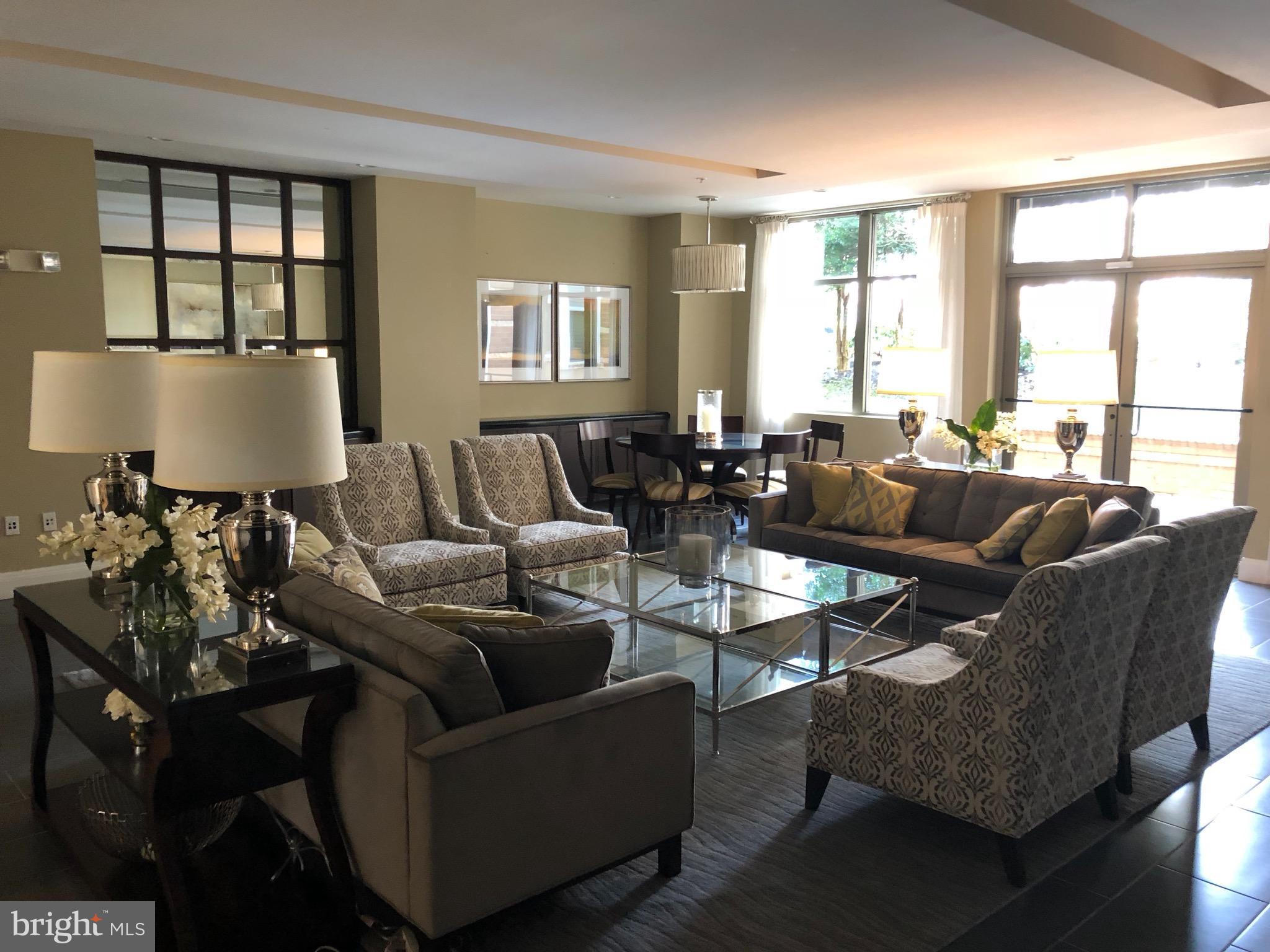 12000 Market Street, Unit 430 Reston, VA 20190 - Photo 17 of 24 a living room with furniture and large windows