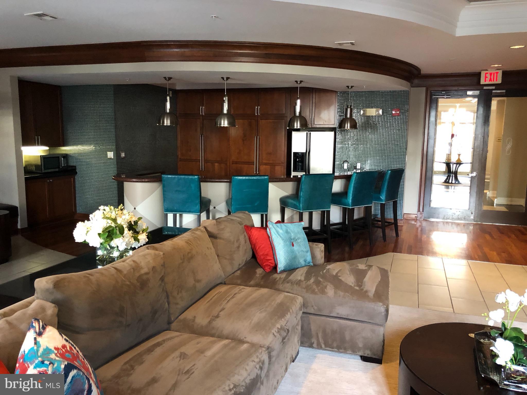 12000 Market Street, Unit 430 Reston, VA 20190 - Photo 19 of 24 a living room with furniture and a chandelier