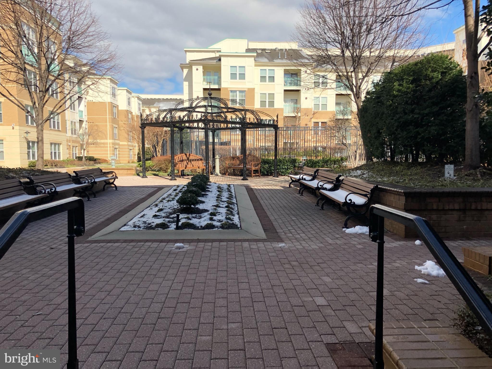 12000 Market Street, Unit 430 Reston, VA 20190 - Photo 22 of 24 a view of a patio with swimming pool table and chairs