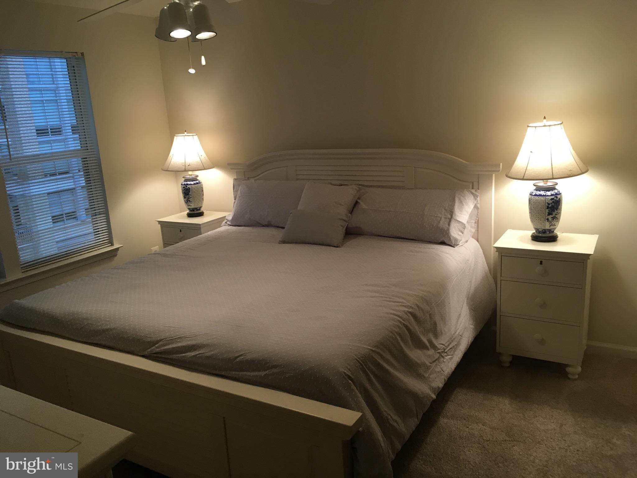 12000 Market Street, Unit 430 Reston, VA 20190 - Photo 7 of 24 a bedroom with a bed and a lamp