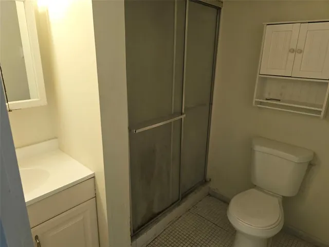 a white toilet sitting next to a sink