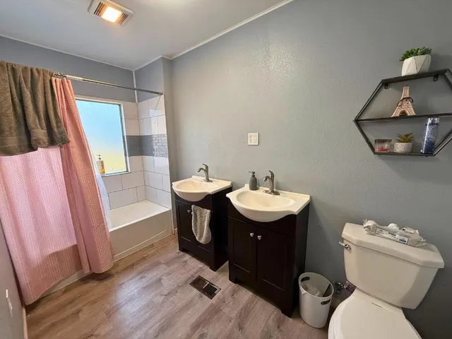 a bathroom with a sink toilet and shower