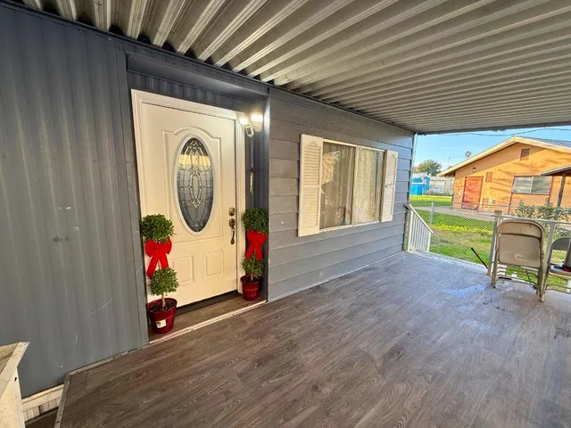 a view of a room with wooden floor and furniture