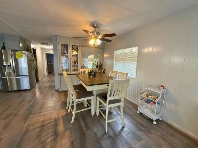 a view of a dining room with furniture wooden floor and chandelier