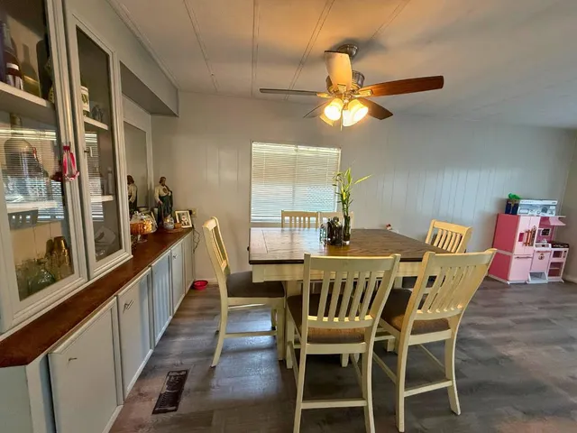 a view of a dining room with furniture and a chandelier