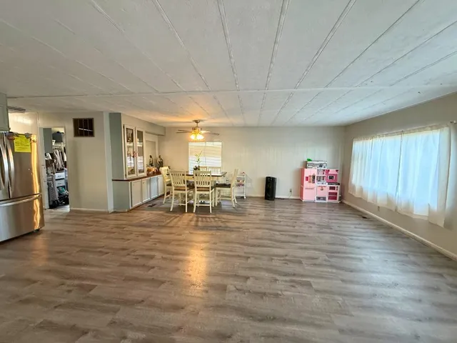a view of a livingroom with furniture nad a kitchen