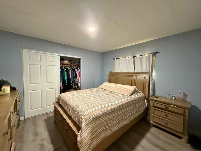 a bedroom with a bed and a closet