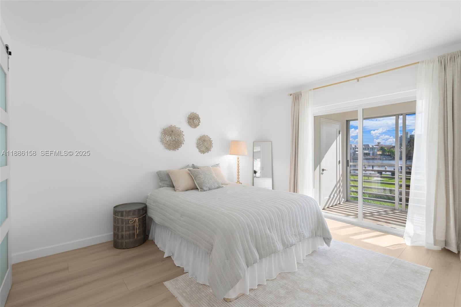 3301 Spanish Trail, Unit 207 Delray Beach, FL 33483 - Photo 17 of 38 a bedroom with a large bed and a window