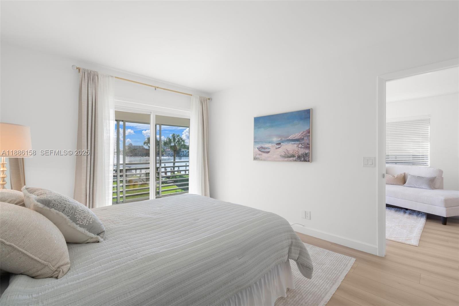 3301 Spanish Trail, Unit 207 Delray Beach, FL 33483 - Photo 18 of 38 a bedroom with a large bed and a window