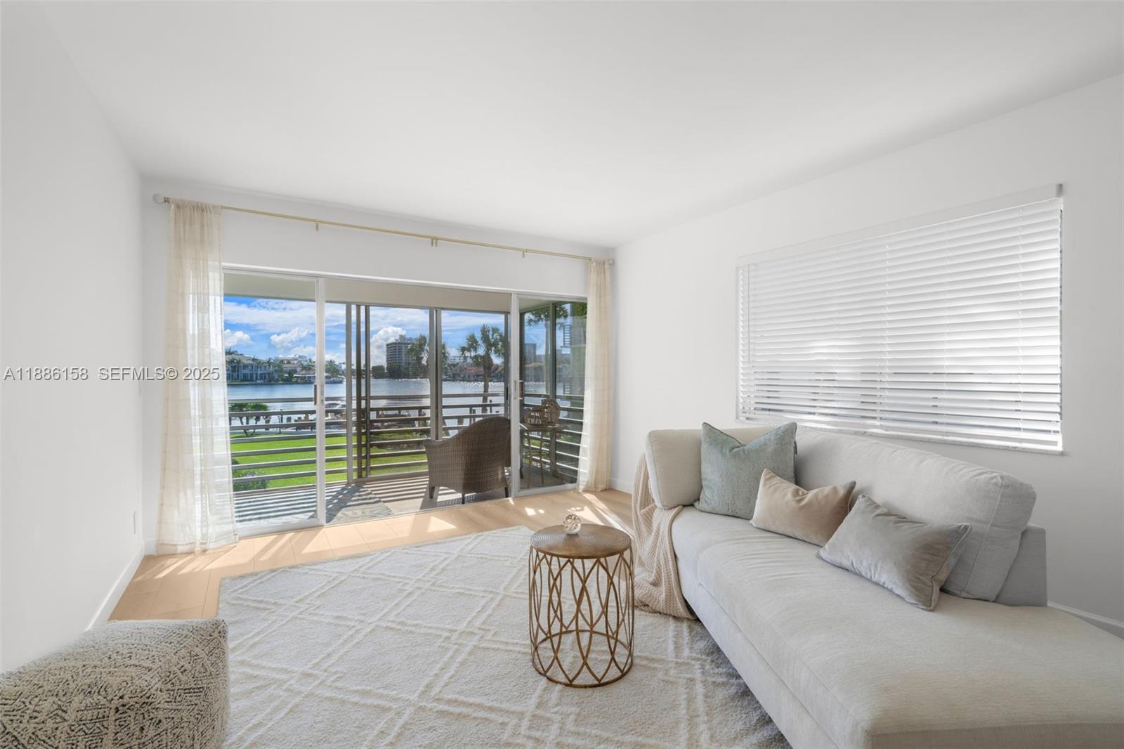 3301 Spanish Trail, Unit 207 Delray Beach, FL 33483 - Photo 21 of 38 a living room with furniture and a large window
