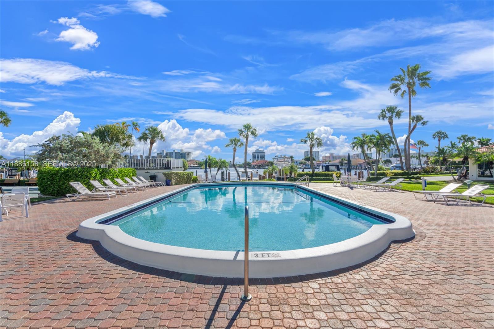 3301 Spanish Trail, Unit 207 Delray Beach, FL 33483 - Photo 25 of 38 a view of a swimming pool with a terrace